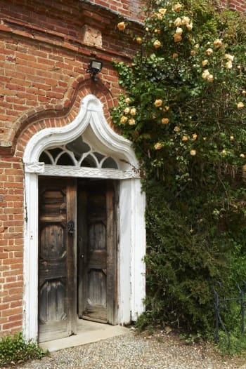 open front door with orange roses