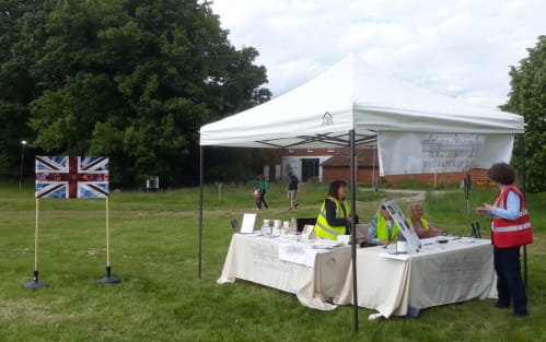 flag and volunteer stand outdoors