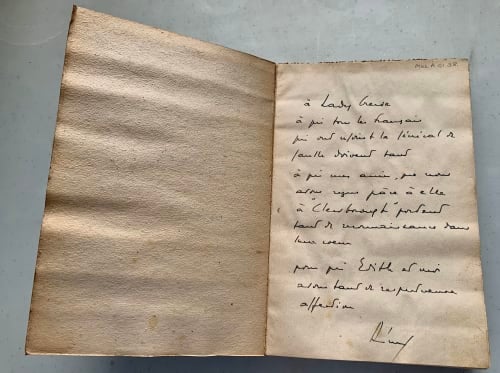 open book with inscription in French