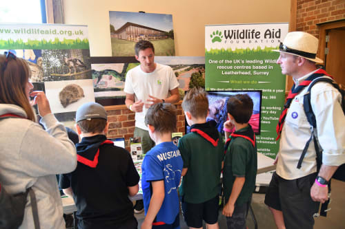 children and cubmaster at nature stand
